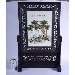 A CHINESE CARVED WOOD AND PORCELAIN SCREEN ON STAND 20th Century, painted with panda within landscap