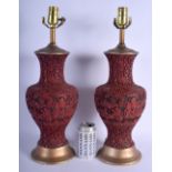 A LARGE PAIR OF 19TH CENTURY CHINESE CARVED CINNABAR LACQUER VASES converted to lamps, decorated wit