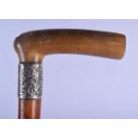 A 19TH CENTURY CONTINENTAL CARVED RHINOCEROS HORN HANDLED WALKING CANE with silver mounts. 88 cm lon