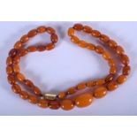 A VINTAGE BUTTERSCOTCH AMBER NECKLACE. 13 grams. 42 cm long, largest bead 1.5 cm wide.