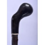 A 19TH CENTURY CARVED BUFFALO HORN HANDLED GNARLED WALKING CANE of naturalistic form. 88 cm long.