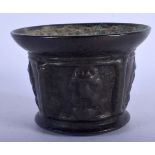 AN EARLY CONTINENTAL BRONZE MORTAR decorated with motifs. 8 cm x 11 cm.