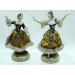 A PAIR OF ANTIQUE GERMAN PORCELAIN FIGURES painted in flowers in various pursuits. 16 cm x 12 cm.