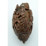 AN 18TH/19TH CENTURY FRENCH CARVED COQUILLA NUT SNUFF BOTTLE formed with figures in various pursuits