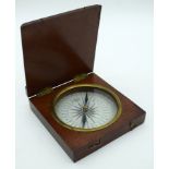 AN UNUSUAL 19TH CENTURY TREEN MAHOGANY CASED COMPASS decorated with fleur de lys. 10.25 cm square.