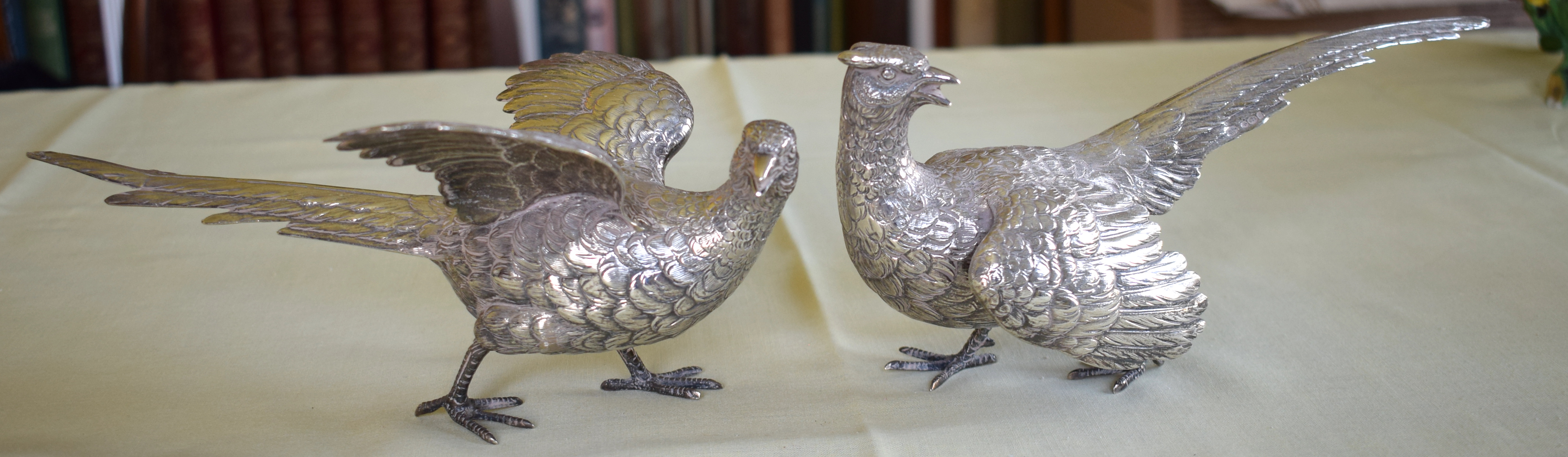 A LOVELY PAIR OF STERLING SILVER TABLE PHEASANTS by F & Son Ltd, well modelled in natural stances. 6