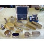 AN ART DECO SILVER DRESSING TABLE SET together with two silver frames, silver topped bottles & jars