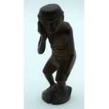 A RARE 18TH/19TH CENTURY CONTINENTAL CARVED WOOD FIGURE OF A MALE modelled holding his tooth. 10 cm