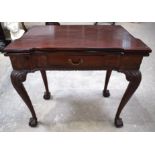 A GEORGE III MAHOGANY FOLD OVER TEA TABLE of unusual form with acanthus capped legs. 80 cm x 75 cm.