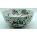 AN EARLY 18TH CENTURY CHINESE EXPORT FAMILLE ROSE BOWL Yongzheng, enamelled with flowers and vines.