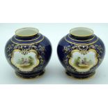 A PAIR OF EARLY 20TH CENTURY COALPORT PORCELAIN VASES painted with birds within landscapes. 12 cm x