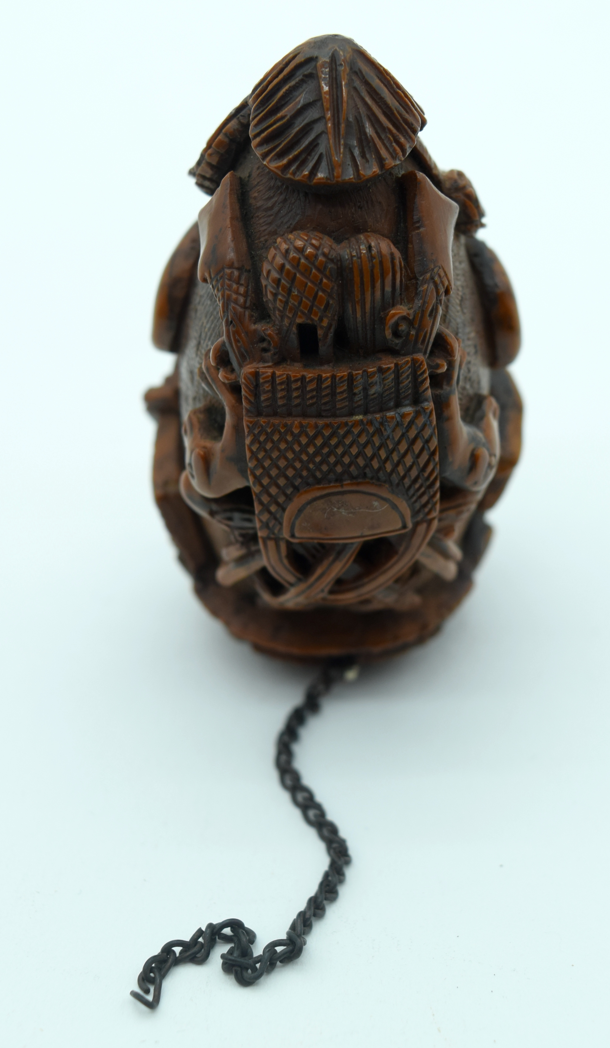 AN 18TH/19TH CENTURY FRENCH CARVED COQUILLA NUT SNUFF BOTTLE decorated with dogs, guns and swords. 6