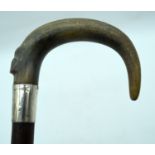 A 19TH CENTURY MIDDLE EASTERN CARVED RHINOCEROS HORN HANDLED WALKING CANE. 90 cm long.