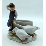 AN 18TH/19TH CENTURY MEISSEN PORCELAIN FIGURE OF A BOY modelled beside two swans. 14 cm x 11 cm.