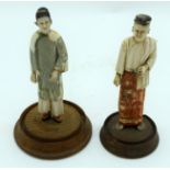 A PAIR OF 19TH CENTURY SOUTH EAST ASIAN POLYCHROMED IVORY FIGURES modelled upon wooden bases. Ivory