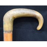 A 19TH CENTURY MIDDLE EASTERN CARVED RHINOCEROS HORN WALKING CANE. 66 cm long.