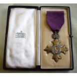 A GEORGE V SILVER GILT CASED OBE MEDAL in original fitted case. Medal 6.5 cm x 4.5 cm.