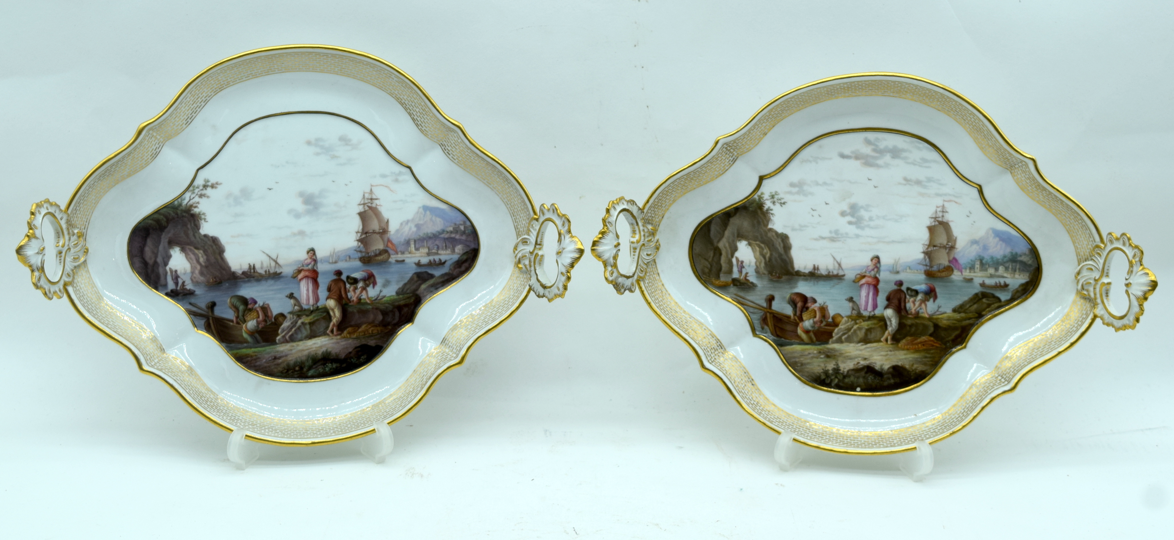 A FINE PAIR OF 18TH/19TH CENTURY MEISSEN TWIN HANDLED PORCELAIN DISHES painted with coastal views. 2