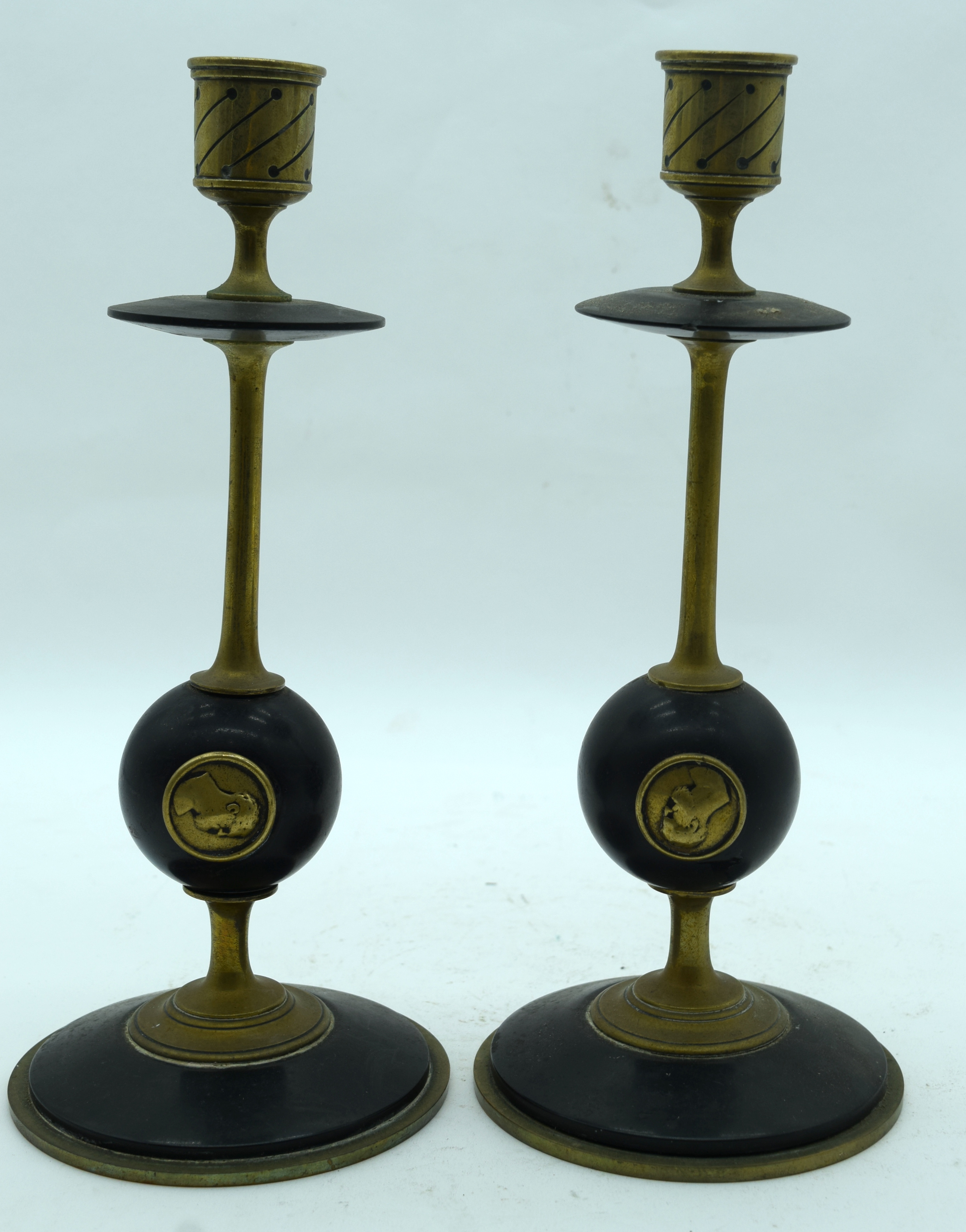 A PAIR OF 19TH CENTURY FRENCH BRASS CANDLESTICKS decorated with portraits. 27 cm high.