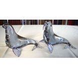 A PAIR OF ITALIAN MURANO GLASS WALRUS modelled with heads raised. 16 cm x 14 cm.