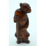 AN 18TH CENTURY JAPANESE EDO PERIOD CARVED WOOD NETSUKE modelled as a scholar holding a staff. 6.5 c