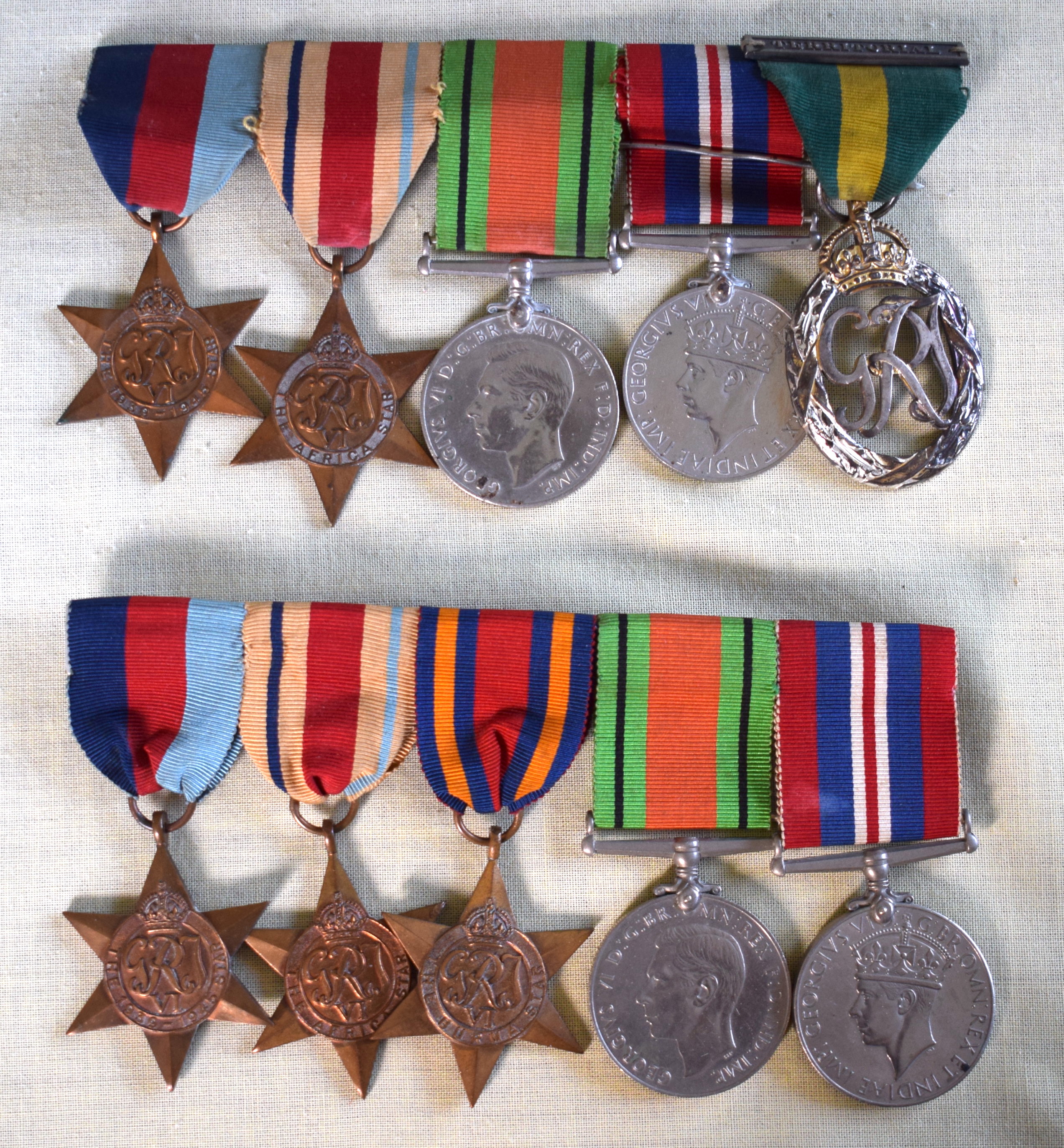 TWO WWII MEDAL GROUPS including territorial, with original ribbons. (10)