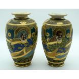 A PAIR OF EARLY 20TH CENTURY JAPANESE MEIJI PERIOD SATSUMA VASES painted with figures. 22 cm high.
