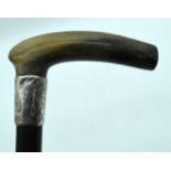 A 19TH CENTURY MIDDLE EASTERN CARVED RHINOCEROS HORN HANDLED WALKING CANE. 90 cm long.