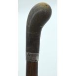A 19TH CENTURY MIDDLE EASTERN CARVED RHINOCEROS HORN HANDLED WALKING CANE. 90 cm long.