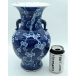A 19TH CENTURY CHINESE TWIN HANDLED BLUE AND WHITE VASE bearing Kangxi marks to base, painted with p