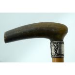 A 19TH CENTURY MIDDLE EASTERN CARVED RHINOCEROS HORN HANDLED WALKING CANE. 90 cm long.