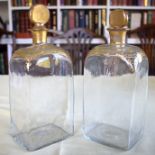 A PAIR OF ANTIQUE BOHEMIAN CLEAR AND GILDED STRAIGHT SIDED GLASS DECANTERS modelled in the neo class