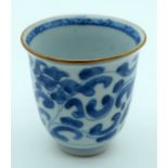 A 17TH/18TH CENTURY CHINESE BLUE AND WHITE PORCELAIN WINE CUP Kangxi/Yongzheng, painted with flowers