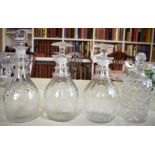 A PAIR OF ANTIQUE CUT GLASS DECANTERS AND STOPPERS together with two other decanters. Largest 23 cm