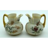 A RARE PAIR OF ROYAL WORCESTER IVORY JUGS of highly unusual form, painted with flowers. 12 cm high.