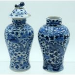 A MATCHED PAIR OF 19TH CENTURY CHINESE BLUE AND WHITE VASES AND COVERS Qing, painted with dragons. L