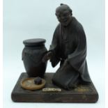 AN EARLY 20TH CENTURY JAPANESE MEIJI PERIOD CARVED WOOD OKIMONO modelled beside a pot. 18 cm x 13 cm