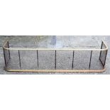 AN ANTIQUE BRASS FENDER. 120 cm x 27 cm.