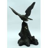 A 19TH CENTURY JAPANESE MEIJI PERIOD BRONZE FIGURE OF A HAWK modelled viewing a toad. 27 cm x 15 cm.