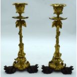 A PAIR OF MID 19TH CENTURY FRENCH ORMOLU AND BRONZE CANDLESTICKS formed as three recumbent toads hol