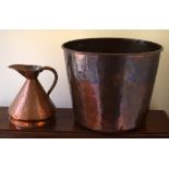 A VINTAGE COPPER WASTE PAPER BASKET, along with a small copper jug. Largest 30 cm x 27 cm. (2)