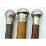 THREE ANTIQUE SILVER TOPPED WALKING CANES. 90 cm long. (3)