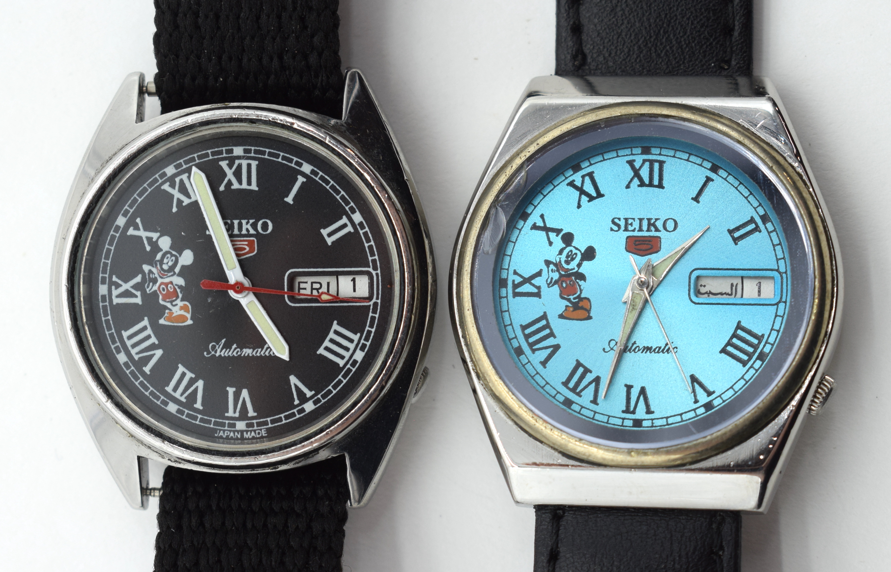 TWO VINTAGE SEIKO MICKEY MOUSE CHROME WRISTWATCHES one with Arabic calendar aperture. 3.5 cm wide. (