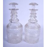 A NEAR PAIR OF GEORGE III CUT GLASS DECANTERS AND STOPPERS. 26 cm high.