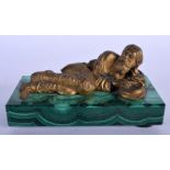 A RARE 19TH CENTURY RUSSIAN GILT BRONZE FIGURE OF A RECLINING MALE modelled upon a malachite base. 1