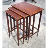 A NEST OF THREE EDWARDIAN MAHOGANY TABLES. Largest 64 cm x 45 cm.