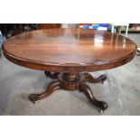 A LARGE VICTORIAN ROSEWOOD BREAKFAST TABLE upon a scrolling acanthus capped base. 148 cm x 73 cm.