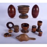 A PAIR OF ANTIQUE TREEN EGG SHAPED BOXES AND COVERS together with other treen. Largest 14.5 cm high.