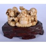 A 19TH CENTURY JAPANESE MEIJI PERIOD CARVED IVORY FIGURE OF BUDDHAS modelled in various pursuits. Iv