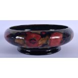 A LARGE WILLIAM MOORCROFT POMMEGRANATE BOWL decorated with fruit. 21 cm diameter.